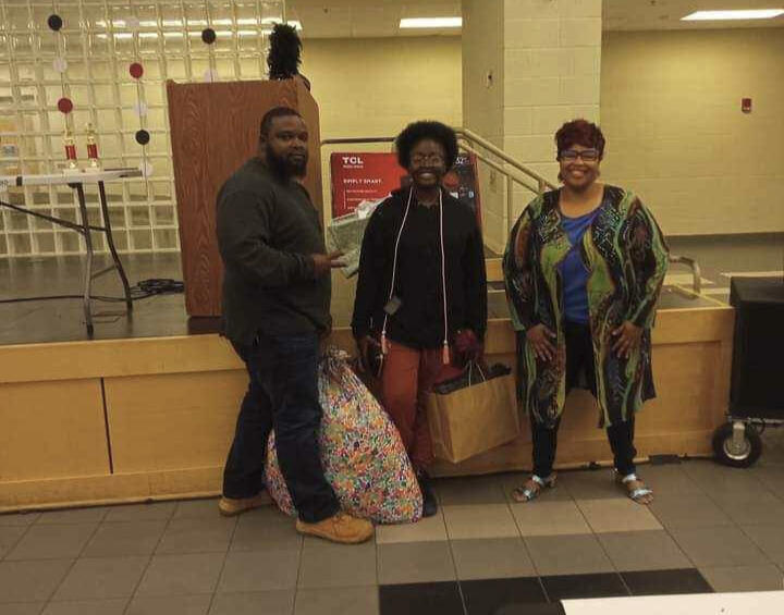 A senior receives a dorm essential scholarship, which includes items for college such as a bed, laundry supplies, a microwave and other dorm room items.