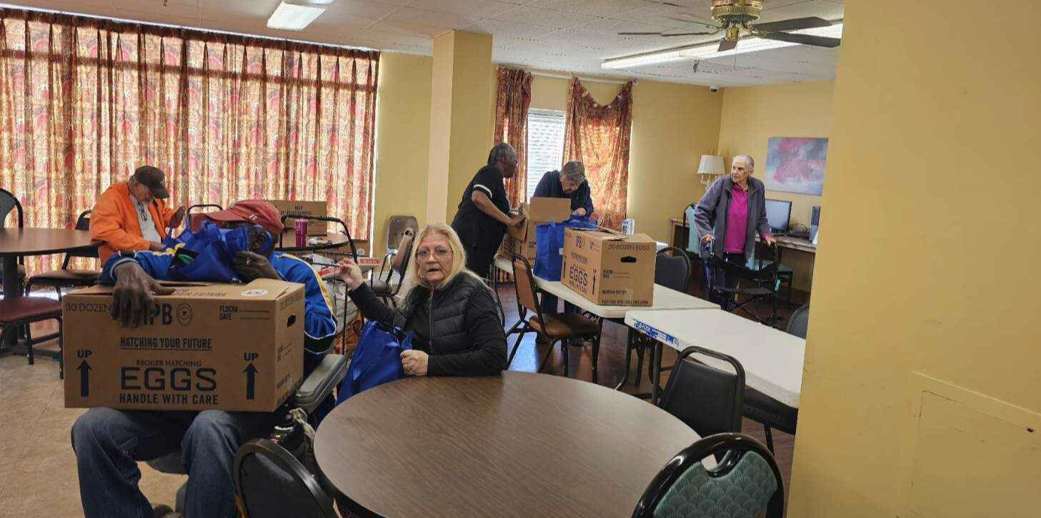Audubon Pointe residents receive food boxes in the lobby