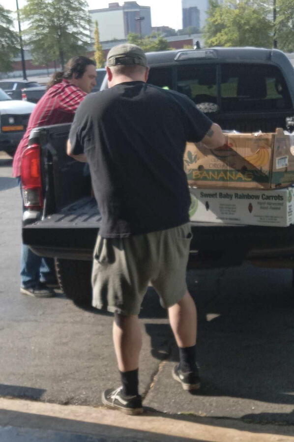 Food Volunteers Volunteers unload food for community distribution