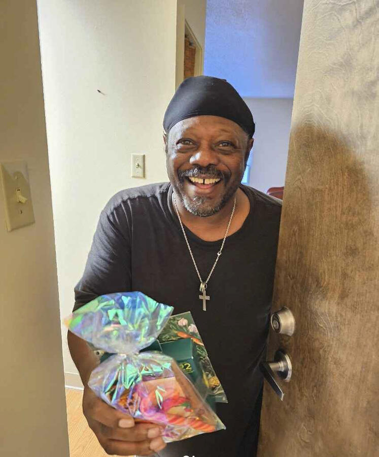 Resident from Audubon Pointe recieves a Christmas package.